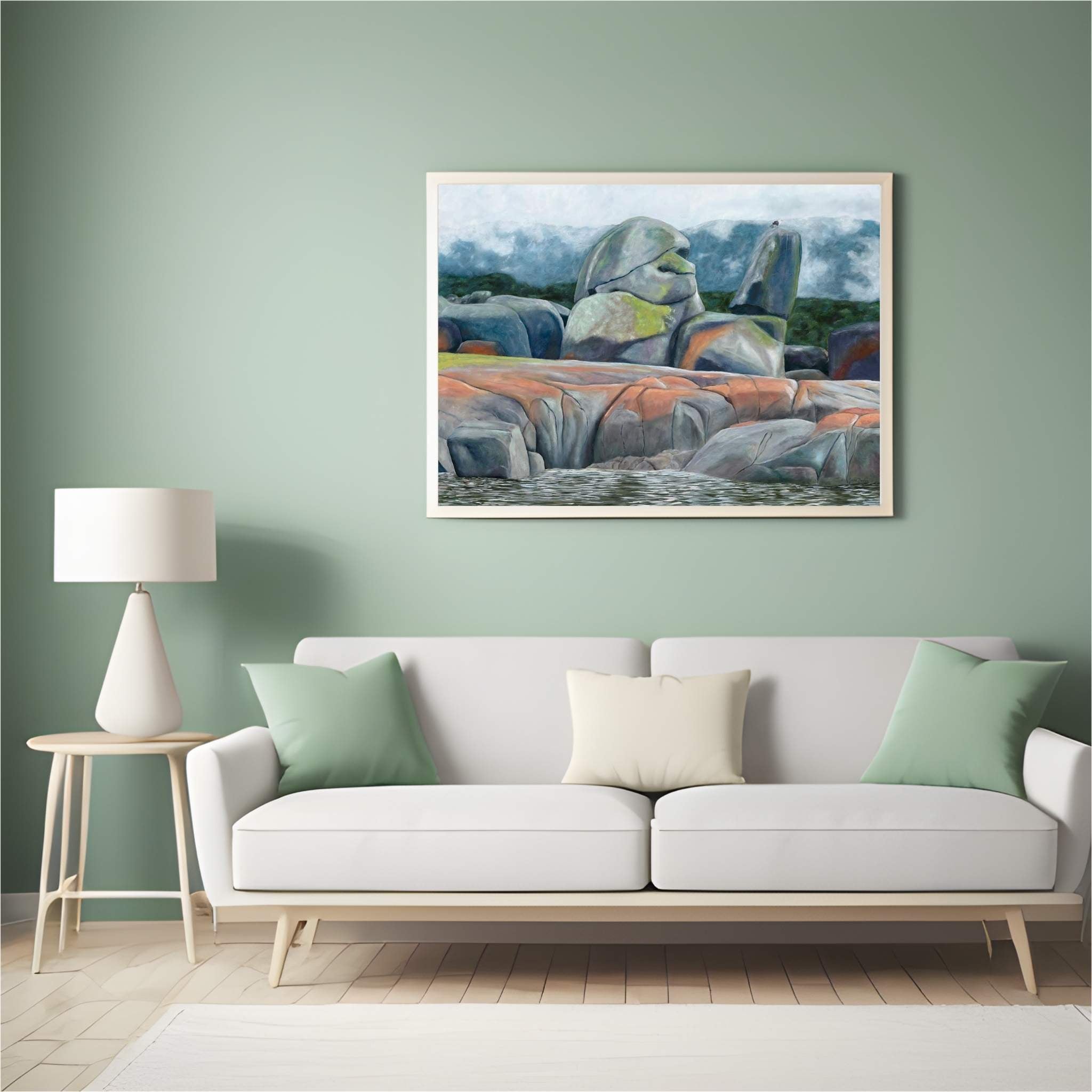 Original painting of rocks across a foggy bay in a living room setting